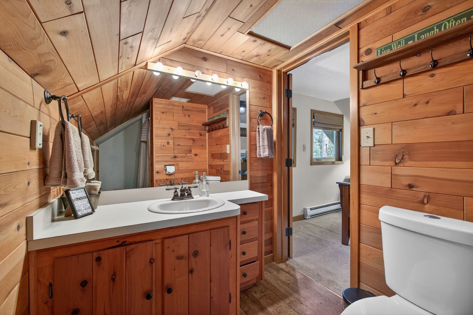 Upstairs bathroom with knotty pine walls