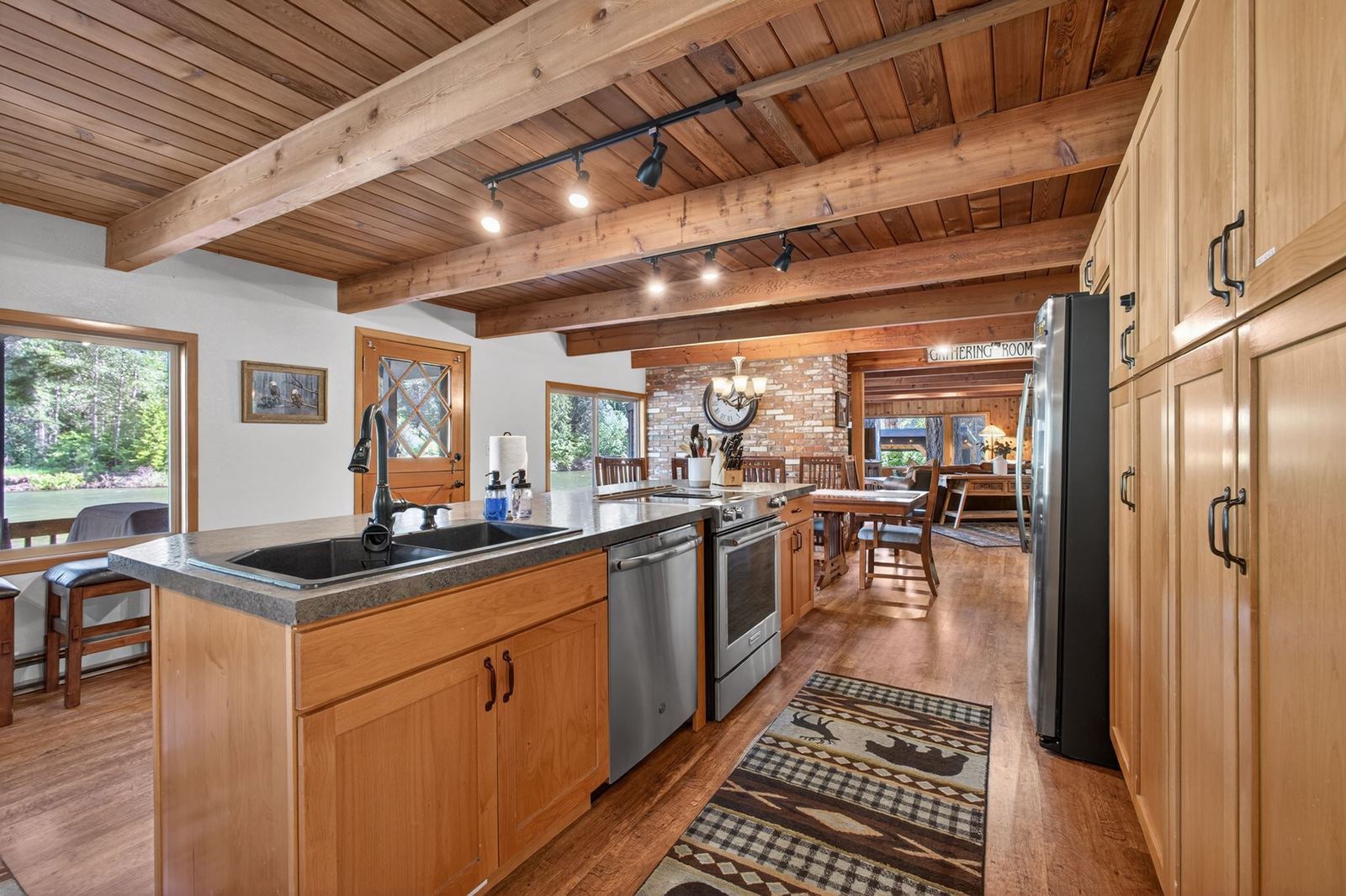 Kitchen island with stainless appliances, open to the dining room
