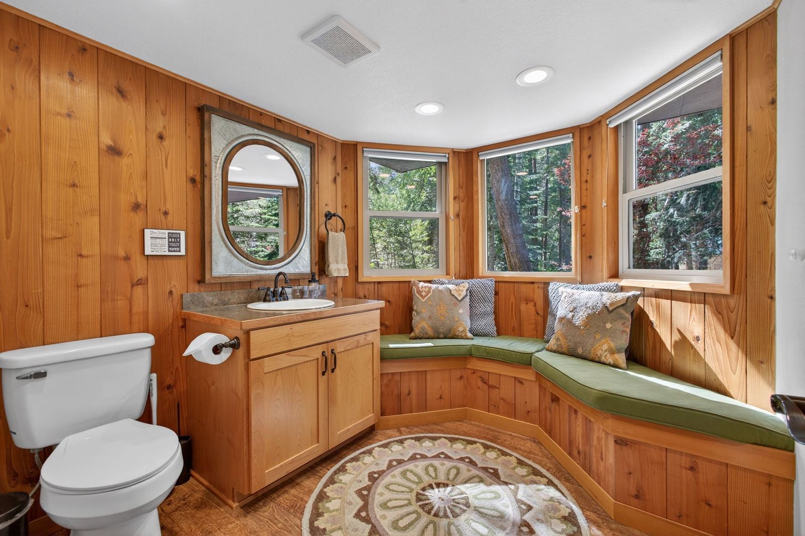 Powder room with a cushioned window seat