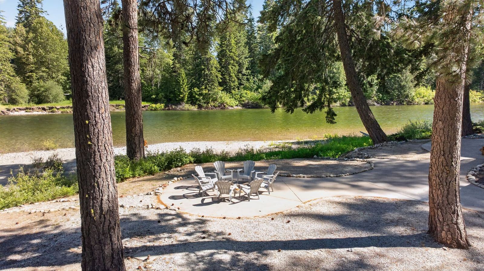 Fire pit under the pines, river beyond